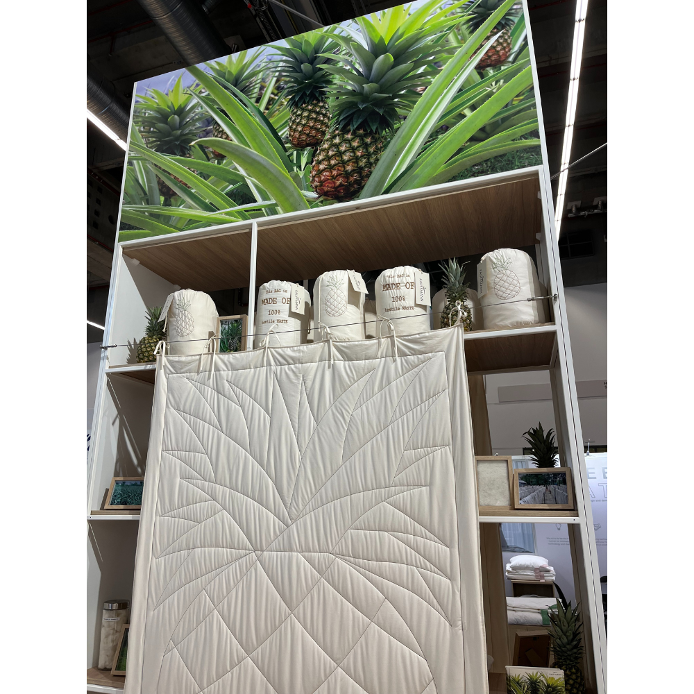 Sanders-Kauffmann booth shelving with folded pineapple leaf fibre quilts and pillows